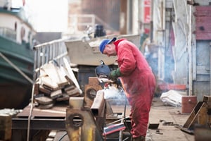 worker-welding-girder-in-shipyard-workshop-2023-11-27-05-18-54-utc
